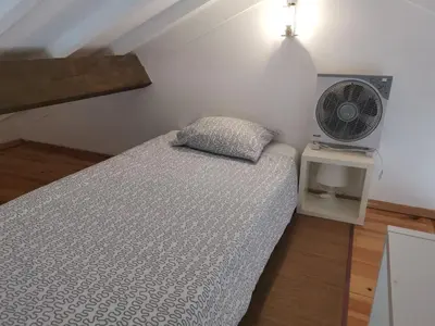 a bedroom with a bed and a fan at YOUR PLACE PORTO I in Porto