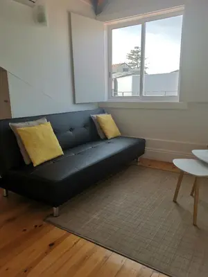 a black couch in a living room with a window at YOUR PLACE PORTO I in Porto