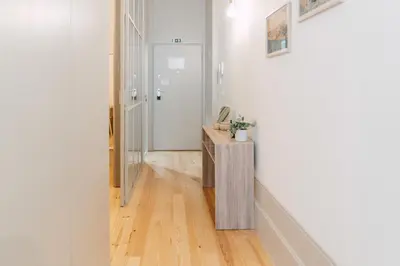 a hallway with white walls and a wooden floor at Casa Burguesa Rua do Almada - Porto city center in Porto