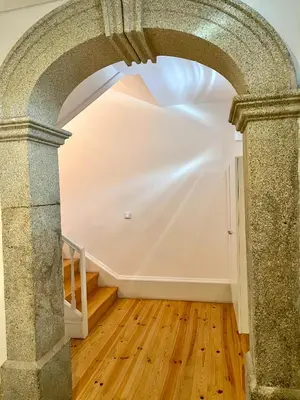 an archway in a room with a wooden floor at Santo António Charming Flat in Porto