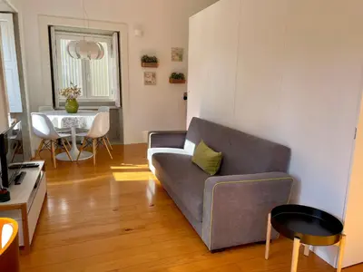 a living room with a couch and a table at Santo António Charming Flat in Porto