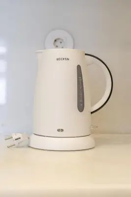 a white toaster sitting on top of a counter at Host Wise - Modern Stuning Flat w Prime Location in Porto