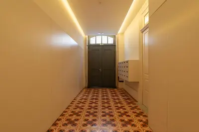 a hallway with a door and a tile floor at Host Wise - Modern Stuning Flat w Prime Location in Porto