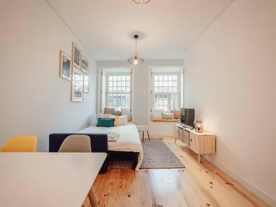 a white room with a bed and a television at OPORTO GUEST Poveiros Home in Porto