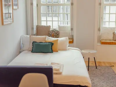 a bedroom with a large white bed with pillows at OPORTO GUEST Poveiros Home in Porto