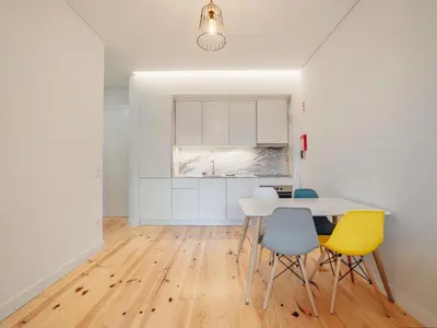 a kitchen and dining room with a table and chairs at OPORTO GUEST Poveiros Home in Porto