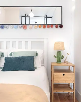 a bedroom with a bed and a cactus on the wall at Vibrant flat by São Bento w/balcony - Loureiro140 in Porto