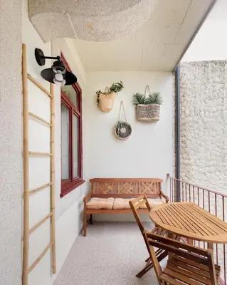 a porch with a bench and a table and a window at Vibrant flat by São Bento w/balcony - Loureiro140 in Porto