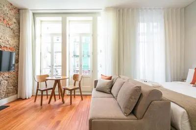 a living room with a couch and a table at Porto River Infante in Porto