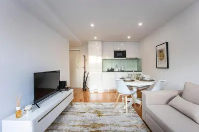 a living room with a couch and a table at City Center 2BR Flat w/ AC by LovelyStay in Porto