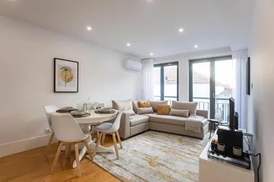 a living room with a couch and a table at City Center 2BR Flat w/ AC by LovelyStay in Porto