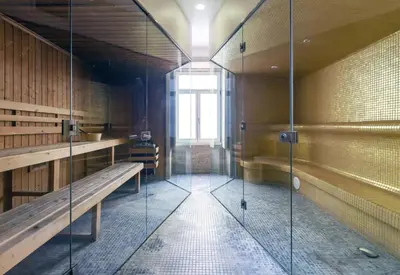 a walk in shower with a bench and a window at Oca Vitoria Village in Porto