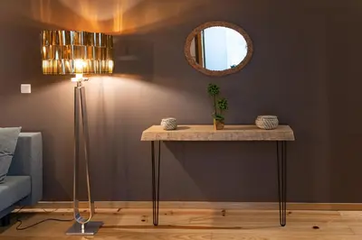 a table in a room with a lamp and a mirror at Rolé Douro - Almada 340 in Porto