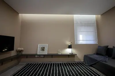 a living room with a flat screen tv on a wall at Birds Apartments in Porto