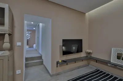 a living room with a couch and two mirrors on the wall at Birds Apartments in Porto