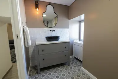 a bathroom with a sink and a mirror on the wall at Birds Apartments in Porto