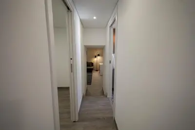 a bedroom with a bed with white sheets and flowers at Birds Apartments in Porto