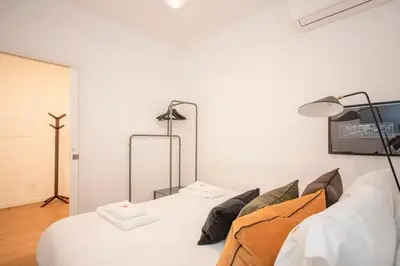 a bedroom with a white bed and two lamps at Liiiving in Porto - Ribeira Vintage View in Porto