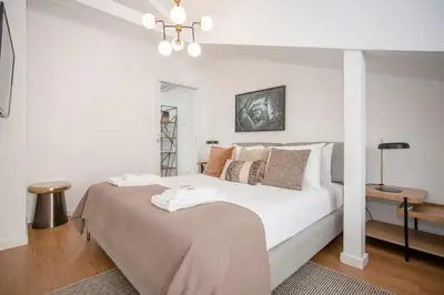 a white bedroom with a large white bed with pillows at Liiiving in Porto - Ribeira Vintage View in Porto