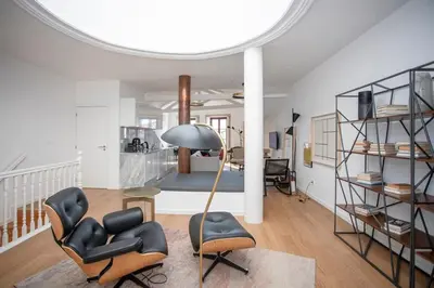 a living room with a lamp and chairs and a bedroom at Liiiving in Porto - Ribeira Vintage View in Porto
