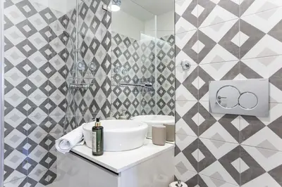 a white bathroom with a sink and a mirror at Homely Studio w/ AC near Marquês by LovelyStay in Porto