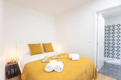 a bedroom with a bed with towels on it at Homely Studio w/ AC near Marquês by LovelyStay in Porto