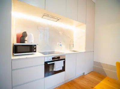 a kitchen with a table and chairs in a room at Oporto City View- Trindade Lovely in Porto