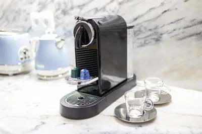 a coffee maker sitting on a counter with two glasses at Sunshine Apartment in Porto