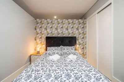 a bedroom with a bed with two towels on it at Camellia Garden in Porto
