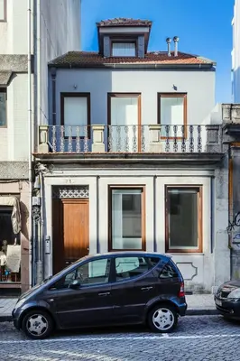 a black car parked in front of a building at Camellia Garden in Porto
