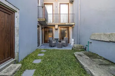 an alley with chairs and a balcony in a building at Camellia Garden in Porto