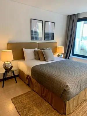 a bedroom with a large bed and two windows at Oporto Chic & Cozy - Oliveiras in Porto
