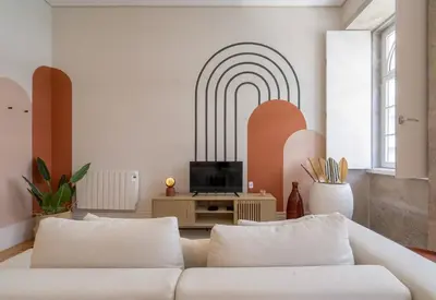 a living room with a white couch and a tv at Habitatio - Aliados by LuxiStay in Porto