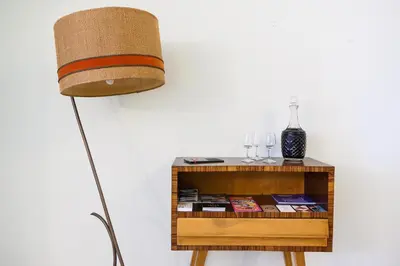 a lamp sitting next to a table with a shelf at Maria da Sé Historic House in Porto