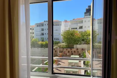 an open window with a view of a patio at Casual Raízes Porto in Porto