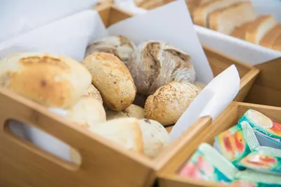 two wooden boxes filled with different types of bread at Casual Raízes Porto in Porto