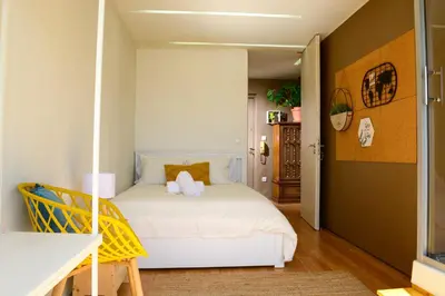 a bedroom with a white bed in a room at Travel & Live Alegria Apartments in Porto