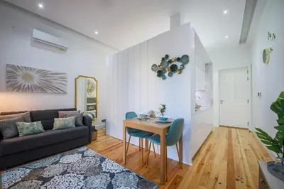 a living room with a couch and a table at THE TWIN Apartments in Porto