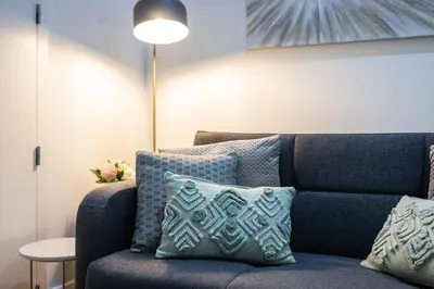 a blue couch with pillows in a living room at THE TWIN Apartments in Porto