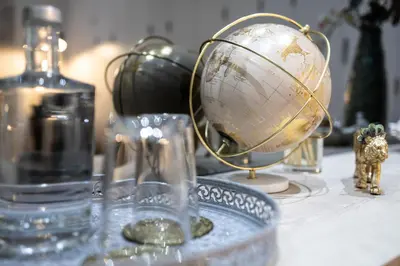 a globe on a table with a bottle and other items at THE TWIN Apartments in Porto