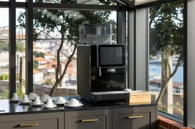a room with a television and a table with cups at CASA CAMÉLIA in Porto