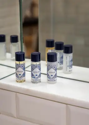a group of four bottles sitting on a bathroom counter at CASA CAMÉLIA in Porto