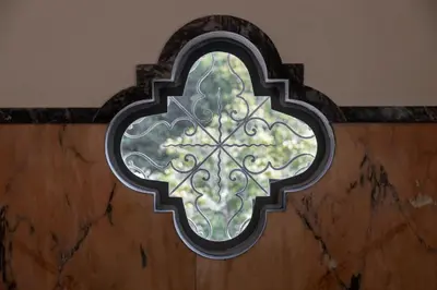 a window in a wall with a metal frame at CASA CAMÉLIA in Porto
