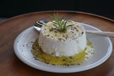 a piece of cake on a plate on a table at CASA CAMÉLIA in Porto