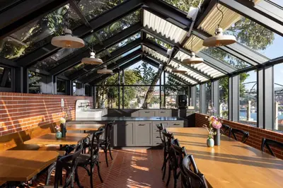 a restaurant with tables and chairs and windows at CASA CAMÉLIA in Porto