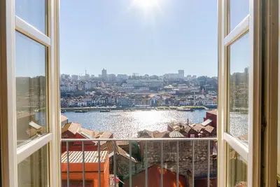 a view of a city from an open window at Award Winning Design Apt City Center - River View by lisbeyond in Porto
