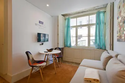 a living room with a couch and chairs and a table at Oporto Blue República - Cozy City Centre Studio in Porto