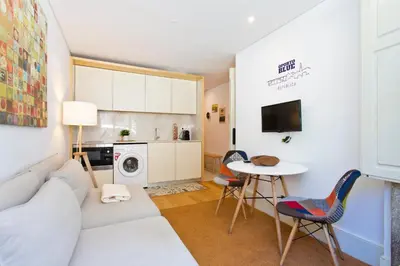 a living room with a white couch and a table at Oporto Blue República - Cozy City Centre Studio in Porto