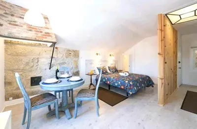 a bedroom with a bed and a table and chairs at Oporto Blue Liberdade - Central Studio with Amazing View and Kitchenette in Porto