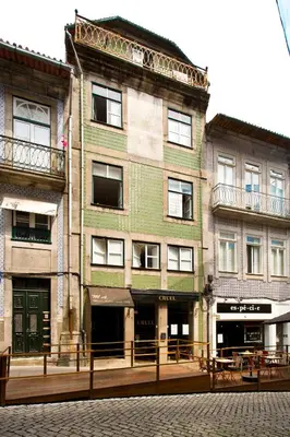 a building on a street with tables in front of it at Oporto Blue Liberdade - Central Studio with Amazing View and Kitchenette in Porto
